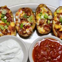 Baked Potato Skins · Large potato skins baked with bacon, jalapenos, tomato and shredded cheese, served with sals...