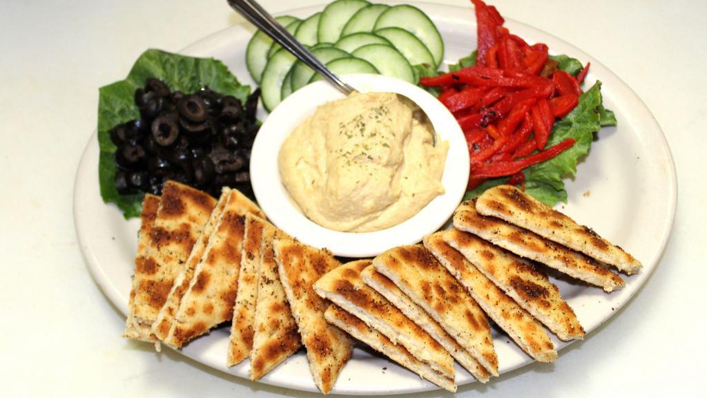 Hummus Platter · Creamy hummus, black olives, cucumbers, roasted red peppers and toasted pita bread seasoned with garlic and pepper.