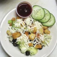 House Salad · Fresh romaine topped with tomato, black olives, mozzarella cheese and croutons served with y...