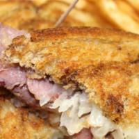 Reuben Sandwich · Thinly sliced house-made corned beef, sauerkraut, Swiss cheese and 1000 Island dressing on g...