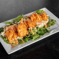 Boom Boom Shrimp · Fried panko covered shrimp served on a bed of baby spinach and coleslaw, topped with house m...