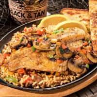 Louisiana Catfish - Bayou Style Lunch · Served over jambalaya rice with garlic bread and salad. Seasoned, skillet seared and topped ...