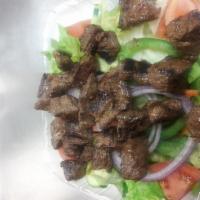 Steak Tips Salad · Garden salad with steak tips on top.