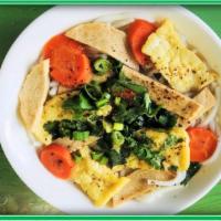 E4. Vegy Soup (Canh Rau Củ) · Rice noodles, onion, carrot, tofu, vegan ham... (Gluten free option)