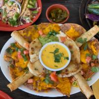 The Fiesta · A little bit of everything - small corn quesadilla, flautas, nachos, guacamole, queso, and s...