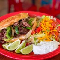 Torta Loca · French bread filled with beef, chicken or
pork fajitas, topped with guacamole, lettuce,
toma...
