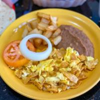 Migas Con Huevo plt · Corn tortilla mixed with eggs, served with potatoes and
refried beans.