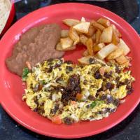 Machacado Con Huevo plt · Carne seca (dry beef), mixed with eggs, tomatoes and
onions; served with beans and potatoes.
