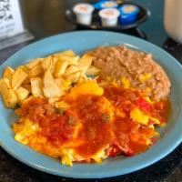 Chilaquiles Con Huevo plt · Corn tortilla chips mixed with eggs, topped with melted
cheese and salsa ranchera; served wi...