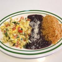 Huevos a la Mexicana · Scrambled eggs with tomato, onions and jalapeno peppers. Accompanied with corn tortillas, ri...