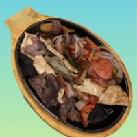 Fajita Mixta · Chicken, steak and shrimp sautéed with onions, peppers and tomato. Served with guacamole, pi...