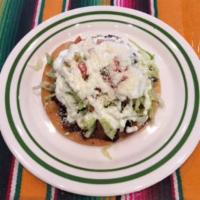 Tostada de Tinga (1 piece) · Chipotle chicken on a hard shell corn tortilla topped with beans, sour cream, mexican cheese...