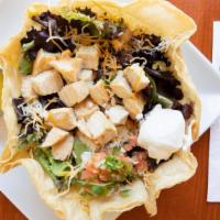 Tostada Salad · Crispy tortilla shell filled with grilled chicken (or steak for an additional charge $2) wit...