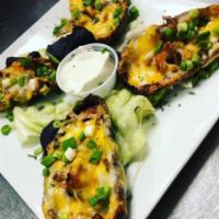 Potato Skins · Crispy potato skins, filled with melty cheddar cheese topped with bacon, sour cream and dice...