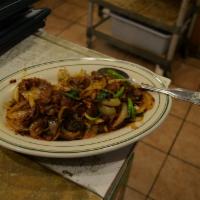 Sichuan Beef · Spicy. Stir-fried with green and yellow onions, cilantro, and chili peppers.
