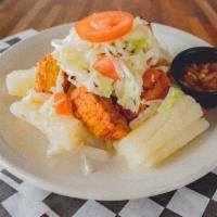 Chancho con Yucca · Yucca with fried pork, and salad on top.