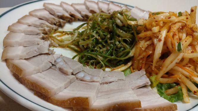 Bossam · Succulent slow boiled pork belly, served with a sweet & spicy radish salad, white kimchi, raw garlic and jalapenos and salted brine shrimp sauce on side. Great for sharing with 2 or more people.  ADD FRESH RAW OYSTERS for $6.00!