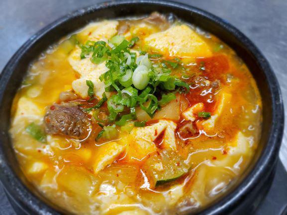 Soon Dubu Jjigae · Organic soft tofu stew cooked with vegetables in a earthenware bowl. (Spicy or NOT Spicy) 
Add an egg! (extra $$)
