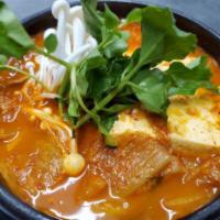 Kimchi Jjigae · Kimchi stew with tender pork morsels, rice cakes, and firm tofu, ubiquitous with Korean cuis...