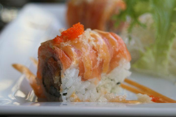 Spicy Girl Roll · Spicy tuna, salmon sashimi, thinly sliced lemon, honey spicy sauce, and tempura flakes.