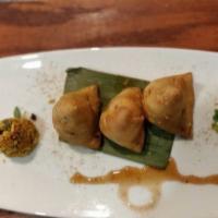 Adraki Samosa · Triangular turnovers filled with potatoes and green peas, a hint of mango powder and flavore...