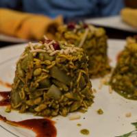 Bhel Puri · Puffed rice crisps with chopped onions, potatoes, avocado and corn kernels tossed with chutn...