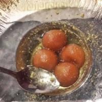 Gulab Jamun · Condensed milk roundels soaked in sugar syrup.