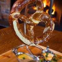 Giant Pretzel · It’s huge!! Soft baked pretzel topped with sea salt, served with smoked Gouda fondue and bre...