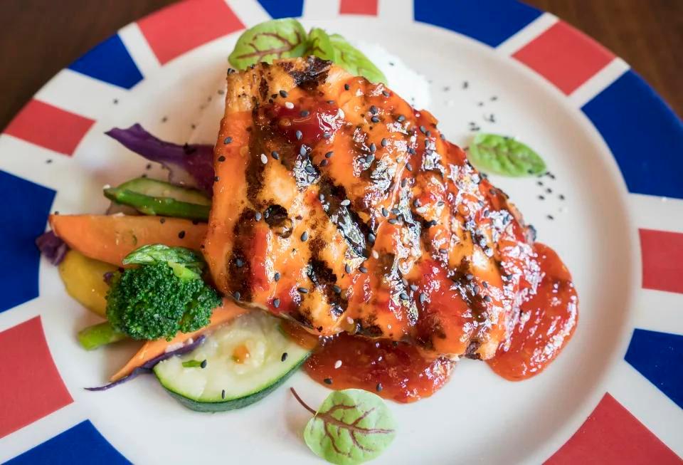 Sweet Thai Chili Salmon · Perfectly grilled North Atlantic salmon glazed with a sweet Thai chili sauce. Served with fresh vegetables and jasmine rice.