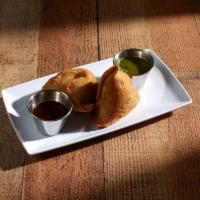 Vegetable Samosa · 2 pieces. Crispy pastry stuffed with delicately spiced potatoes, peas and herbs. 