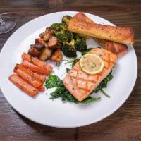 Grilled Salmon · Grilled marinated wild caught Atlantic salmon served with sauteed spinach, roasted red bliss...