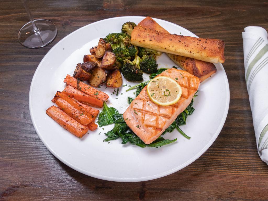 Grilled Salmon · Grilled marinated wild caught Atlantic salmon served with sauteed spinach, roasted red bliss potatoes and seasonal vegetables. Served with grilled garlic ciabatta bread.