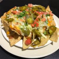 Dock's Mega Nachos · Housemade tortilla chips, refried beans, 3 cheeses, lettuce, tomato and jalapenos. Served wi...
