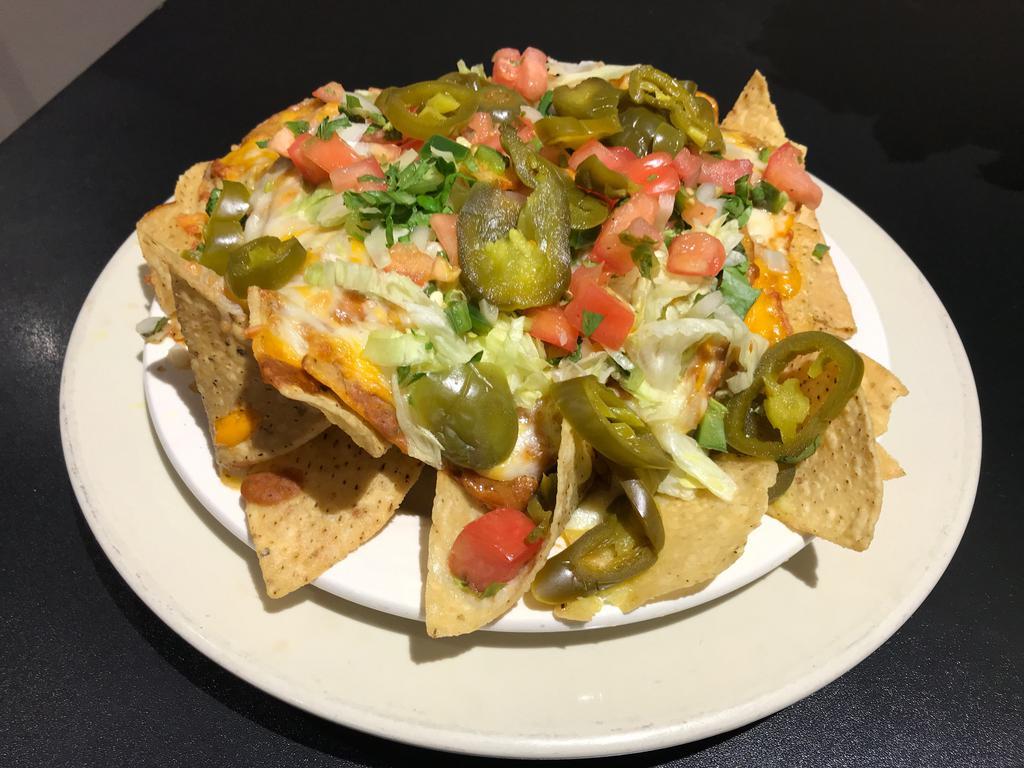 Dock's Mega Nachos · Housemade tortilla chips, refried beans, 3 cheeses, lettuce, tomato and jalapenos. Served with pico de gallo, sour cream and guacamole. Add meat for an additional charge.