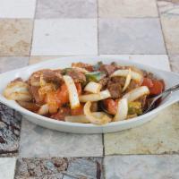 Awaze Siga Tibbs · Tender tip pieces of marinated beef cooked with berbere sauce, onions, jalapenos peppers, a ...