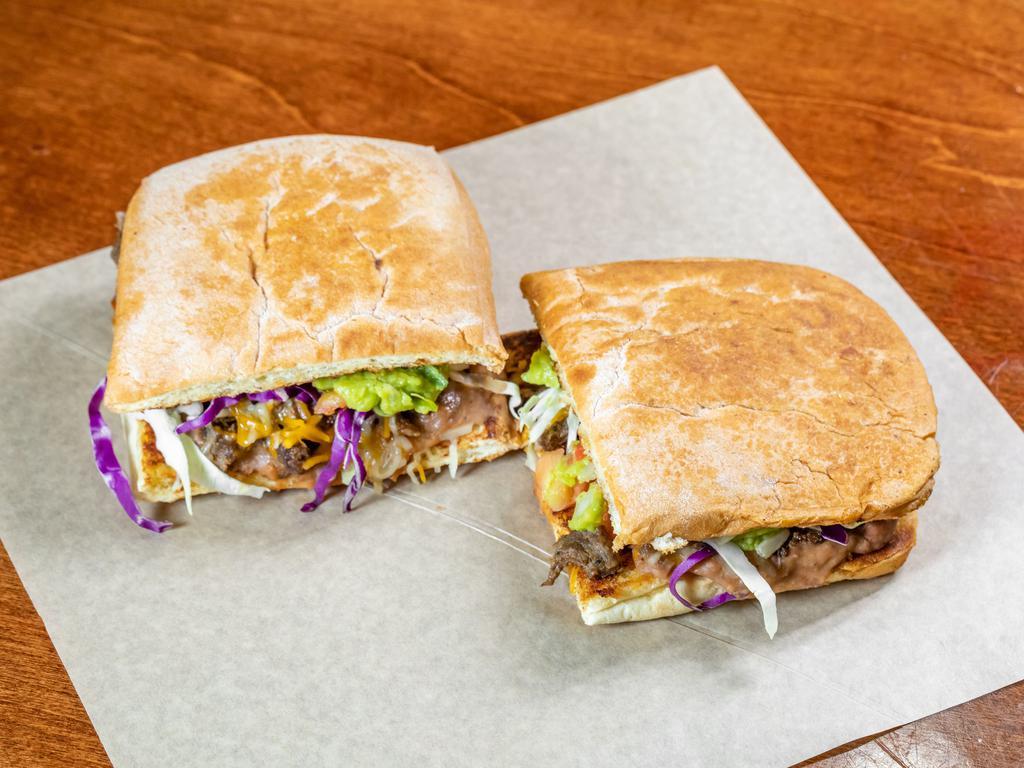 Slow Roasted Carnitas Torta (pork) · Mexican sandwich served on a bread roll.