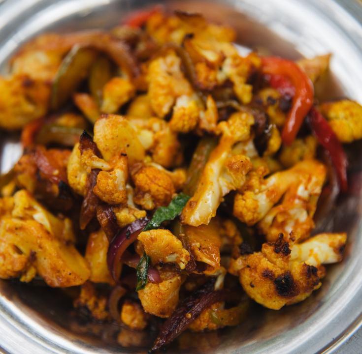 Roasted Cauliflower (GF) · Roasted cauliflower with sautéed onions and bell peppers, tossed in an Indo-Chinese sweet and spicy sauce