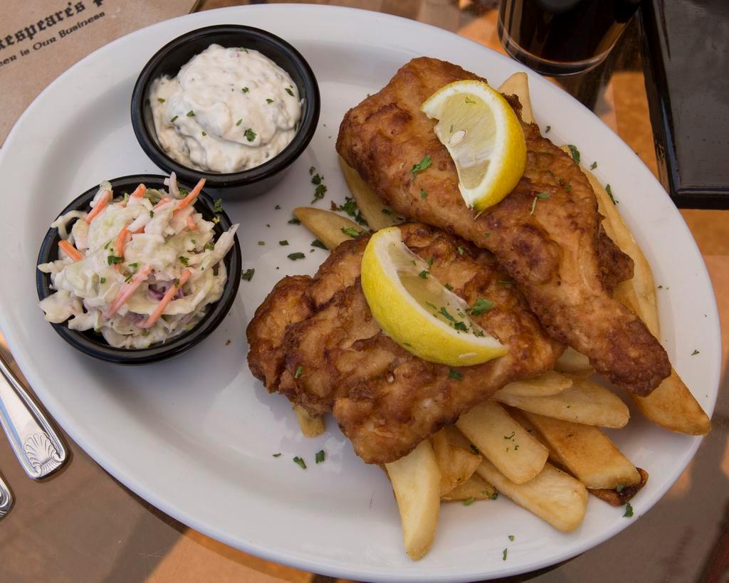 Shakespeare's Famous Fish & Chips · Fresh cod lightly beer battered and served over steak fries, served with coleslaw and tartar sauce.