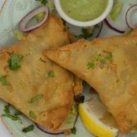  Vegetable Samosa (two pieces) · Seasoned potatoes, green peas and house spices wrapped in a light deep-fried pastry dough.