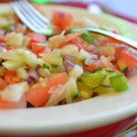 7. Kachumber Salad · Diced cucumbers, tomatoes, bell peppers and cilantro. Topped with lemon juice and spices.