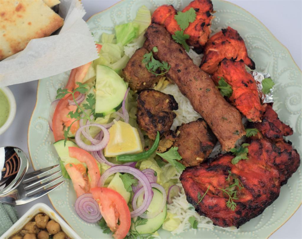 18. City Kabob Sizzling Feast for 2 · Combination of 3 pieces boneless chicken, 3 pieces of lamb 1 skewer of ground beef kabob and 1 piece of tandoori chicken. Served with salad, white basmati rice,2 naan bread, 2 chickpeas, salad and sauces