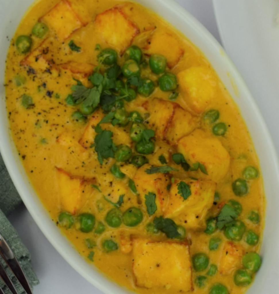 27. Mutter Paneer · Green peas cooked in cottage cheese and house spices. Served with basmati rice. Vegetarian.