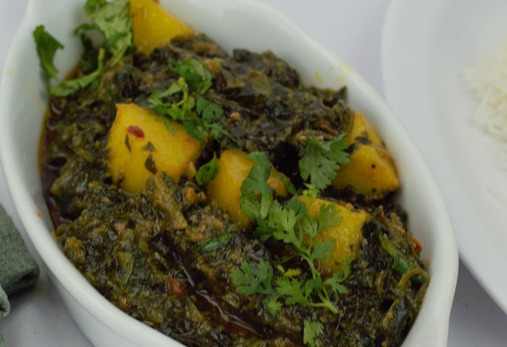 29. Aloo Saag · Fresh spinach ant potatoes cooked in house spices served with basmati rice. Vegetarian.