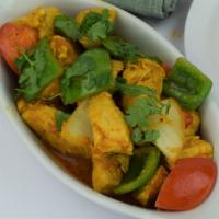 37. Chicken Kadai · Chicken cooked with fresh ginger, cilantro, diced tomatoes, onions and bell peppers with hou...