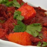 44. Lamb Vindaloo · Lamb and potatoes cooked in fiery hot sauce and house spices. Served with basmati rice.