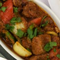 45. Lamb Kadahi · Lamb cooked with fresh ginger, garlic, cilantro, diced tomatoes, onions and bell peppers wit...