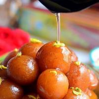 64. Gulab Jamun · Dry cottage cheese balls dipped in honey syrup and rose water.