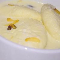 65. Rasmalai · Cottage cheese balls and special condensed milk flavored with rose water topped with crushed...