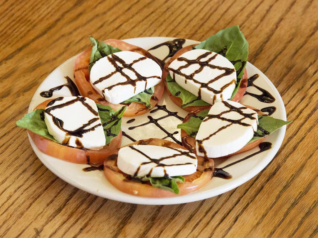 Caprese Plate · Slices of fresh tomato and Buffalo mozzarella with basil leaves. Drizzled with balsamic glaze.