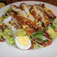 Crispy Chicken Salad · Breaded chicken strips, mixed lettuce with bacon, egg, onion, tomato and cheddar.
